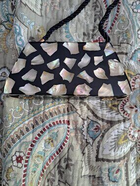 9x4x6 purse features an inlay of iridescent shell pieces, likely mother of pearl